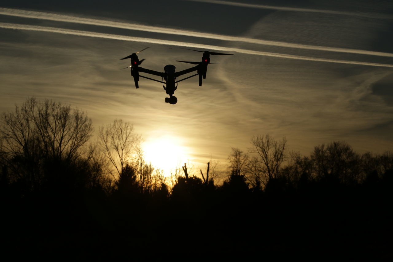 LOW ANGLE VIEW OF SILHOUETTE MAN AGAINST SKY AT SUNSET