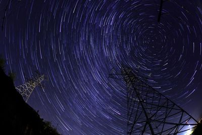 Directly below shot of star trails in sky at night