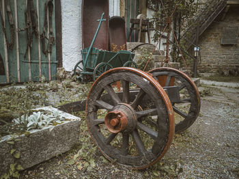 Old rusty wheel by building