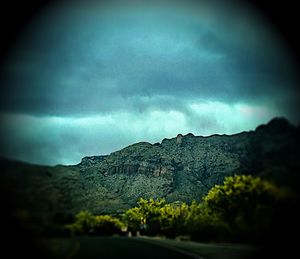 Scenic view of mountain against dramatic sky