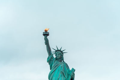 Low angle view of statue against blue sky