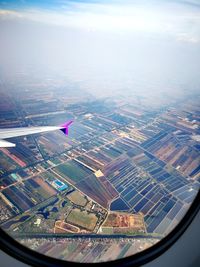 Aerial view of cityscape seen through airplane window