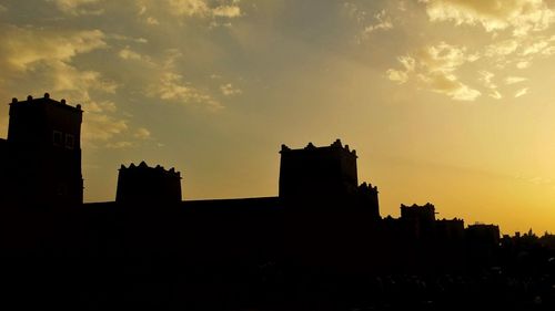 Silhouette buildings against sky during sunset