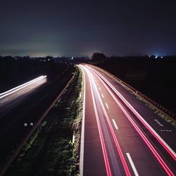 High angle view of light trails on highway at night