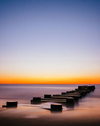 Scenic view of sea against clear sky during sunset