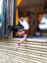 Cute girl looking through window