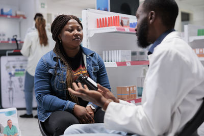 Side view of female friends working at clinic