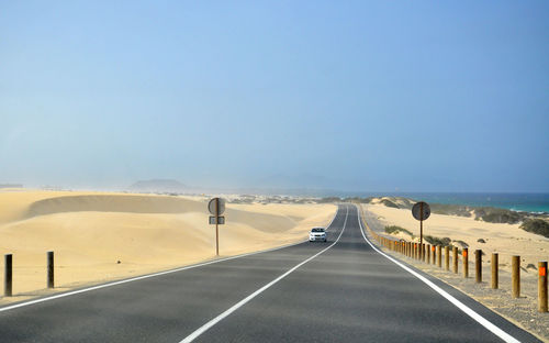 Empty road against clear sky