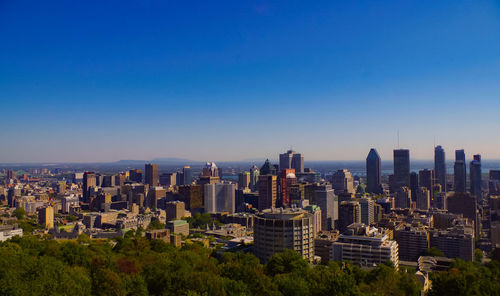 High angle view of cityscape against blue sky