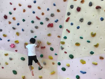 A child is bouldering.