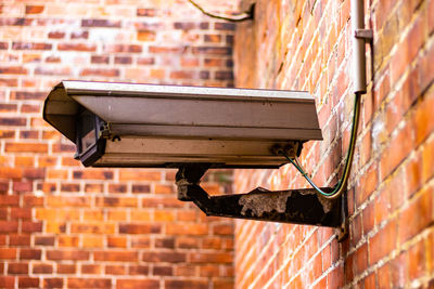 Close-up of brick wall against building