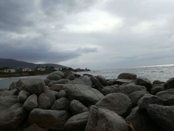 Pebbles on beach against sky