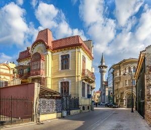 Street amidst buildings against sky in city