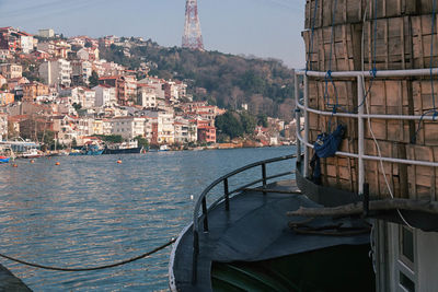 Boats in river with buildings in background