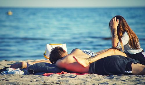 Woman lying down on beach