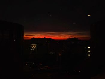Illuminated city against sky at night