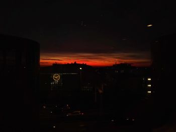 Illuminated city against sky at night