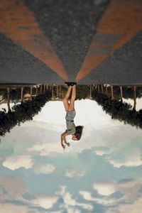 Reflection of man jumping on mirror