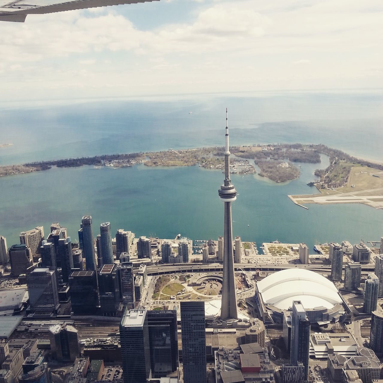 architecture, built structure, building exterior, city, cityscape, tower, sky, travel destinations, sea, famous place, international landmark, capital cities, water, tourism, tall - high, communications tower, crowded, travel, cloud - sky, residential district