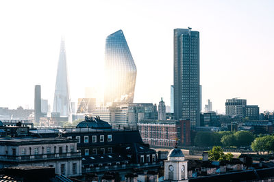 Modern buildings in city against clear sky