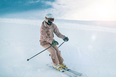 Man skiing on snow against mountain