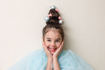 Portrait of funny girl with a hairstyle in the form of a christmas tree