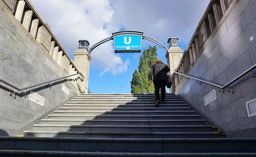 Low angle view of woman moving up on staircase