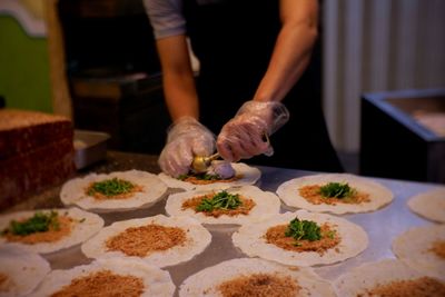 Close-up of man preparing food on table