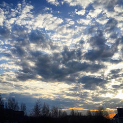 Low angle view of cloudy sky at sunset