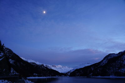 Scenic view of lake and snowcapped mountains against sky