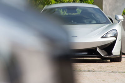 Close-up of car on road