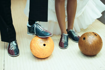 Low section of women standing on floor blowing wedding 