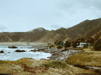 Scenic view of lake and mountains against sky