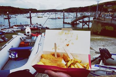 Close-up of food on table by sea