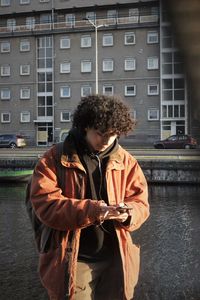 Man standing against building in city