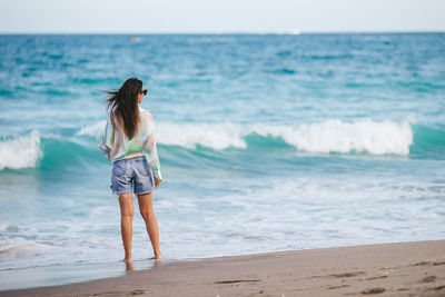 Young woman standing at beach