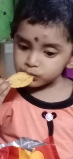 Close-up portrait of cute boy holding ice cream