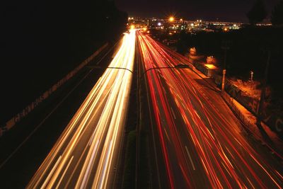 Streaks of lights of moving vehicles on road at night