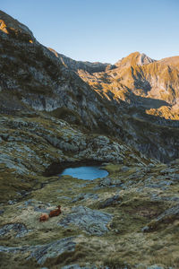 A scenic view on a mountain lake in the pyrenees during sunrise.