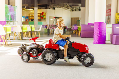 Portrait of woman holding toy car