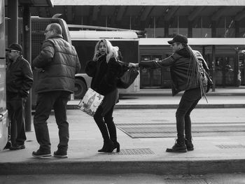 People walking on sidewalk in city