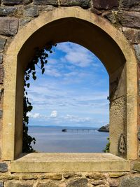 Scenic view of sea against sky seen through arch bridge