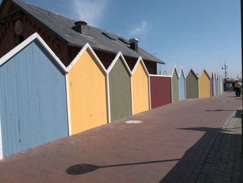 Row of houses on beach against sky