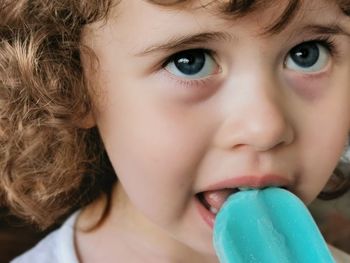 Little girl enjoying her blue popsicle.