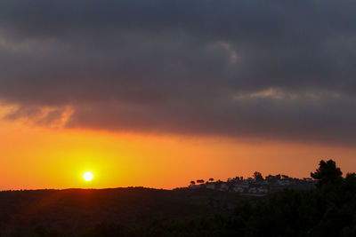 Scenic view of landscape against orange sky