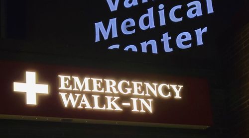 Low angle view of illuminated sign on wall