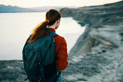 Rear view of woman standing in water