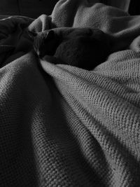 High angle view of man relaxing on bed