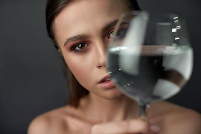 Close-up portrait of a woman drinking glass