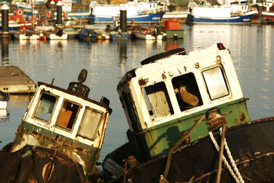 Abandoned boats moored at shore